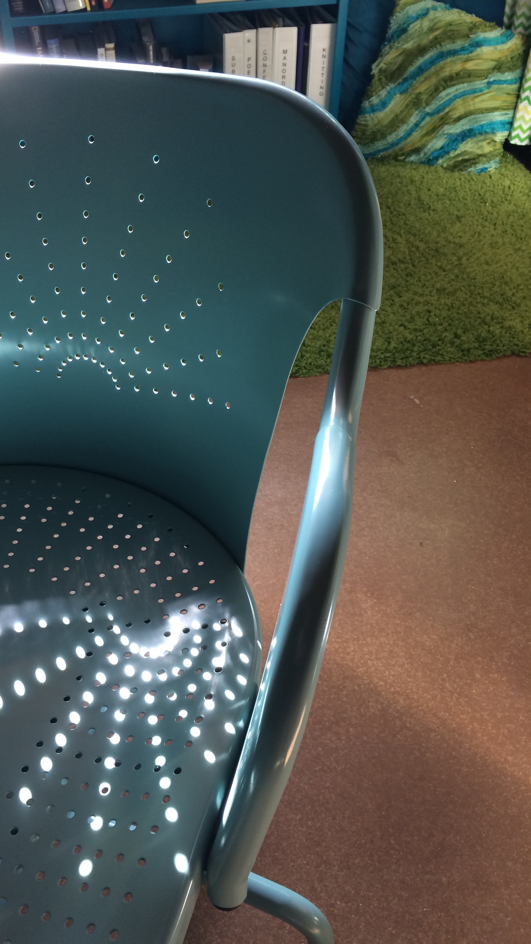 turquoise metal chair with sun pattern